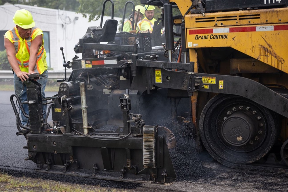 An Allegheny County Public Works Laborer operates a paving machine